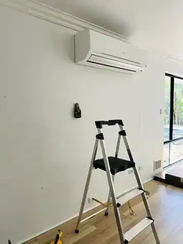 Room photographed before an acoustic-panel media wall installation